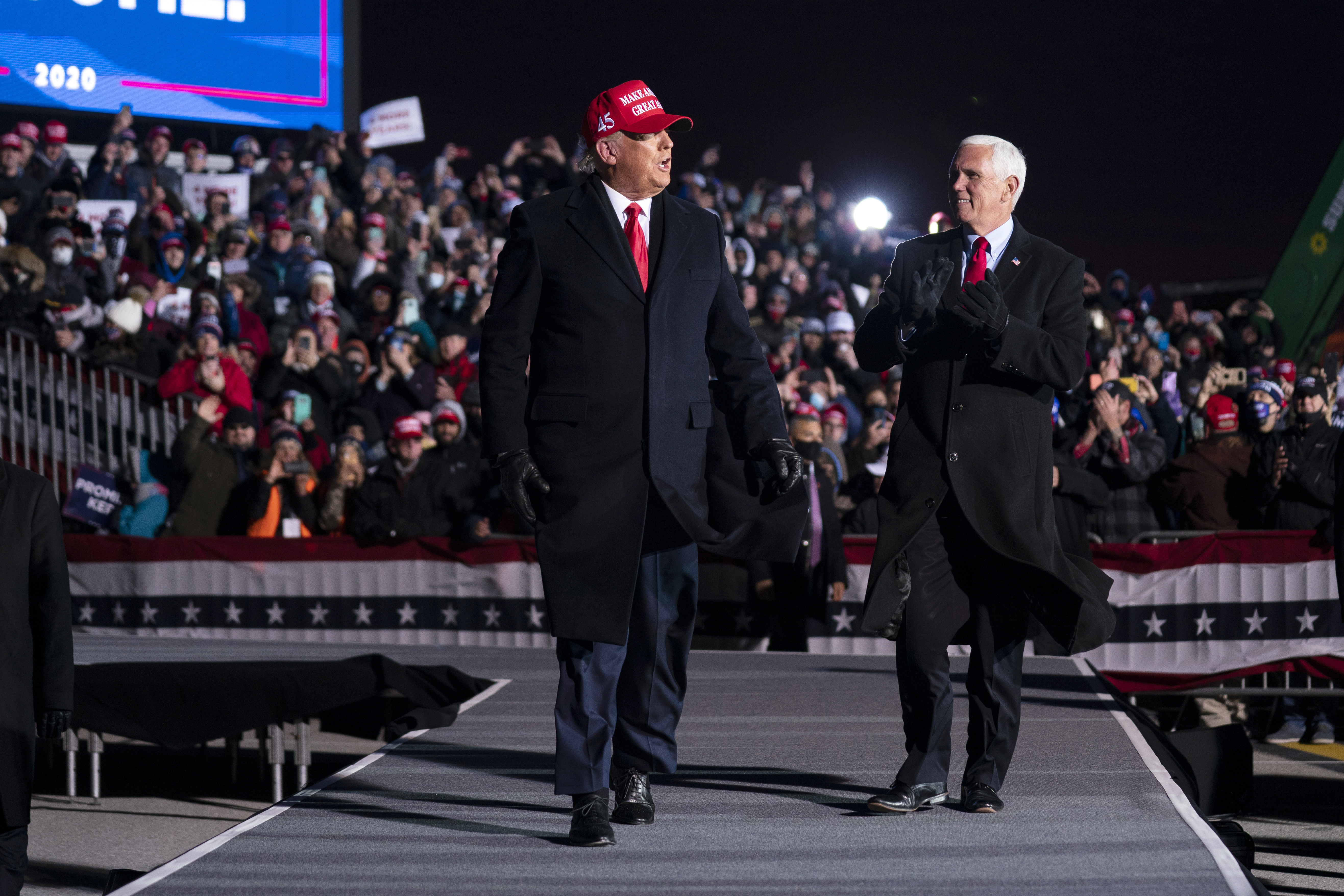 President Donald Trump and Vice President Mike Pence arrive for a campaign rally at Cherry Capital Airport, Monday, Nov. 2, 2020, in Traverse City, Mich. (AP Photo/Evan Vucci)